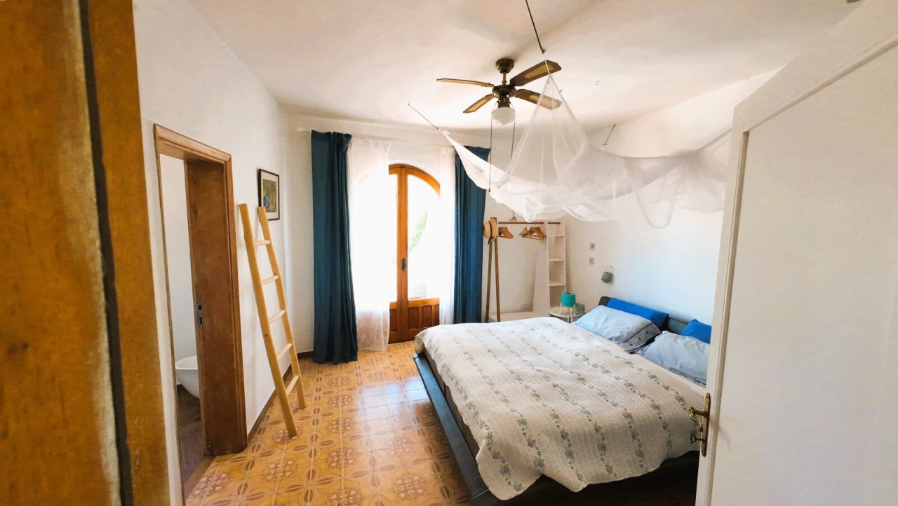 Charmantes Schlafzimmer mit Altbau-Charakter: Mediterrane Zementfliesen und rustikale Holztür schaffen einzigartige Wohlfühlatmosphäre!