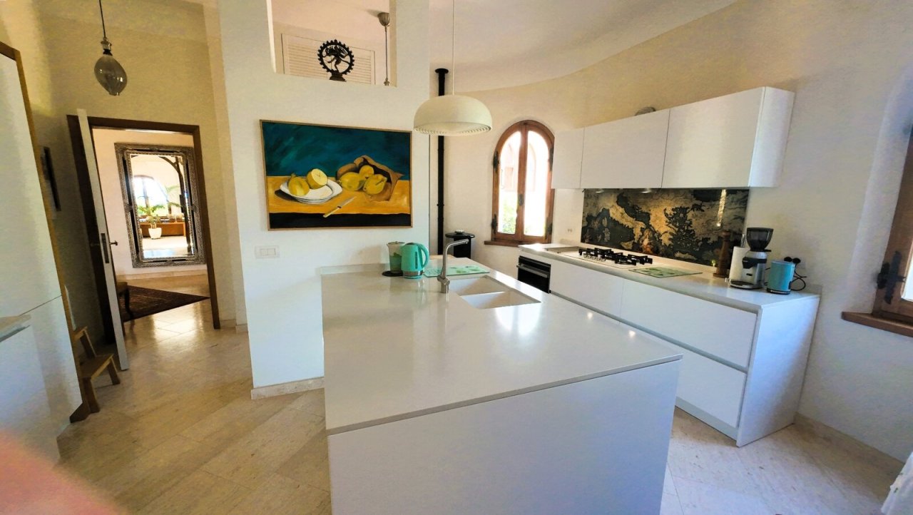 Brightly lit designer kitchen with island - modern functionality meets Mediterranean elegance