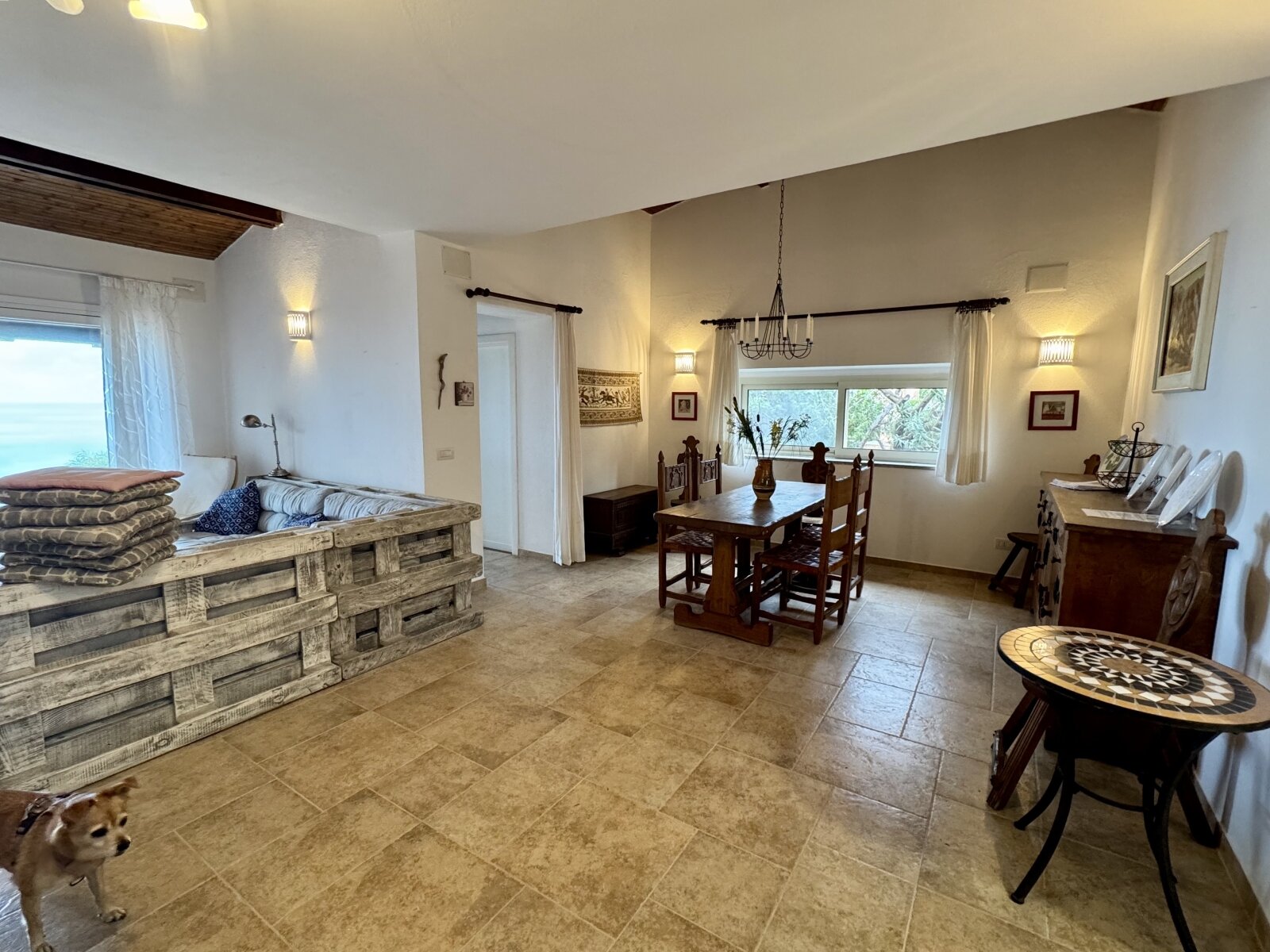 Brightly lit living-dining area with high-quality natural stone flooring and elegant layout Brightly lit living-dining area with high-quality natural stone flooring and elegant layout