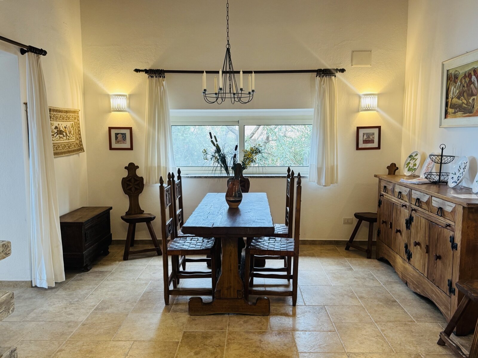 Inviting dining area with natural light and Mediterranean stone floor charm Inviting dining area with natural light and Mediterranean stone floor charm