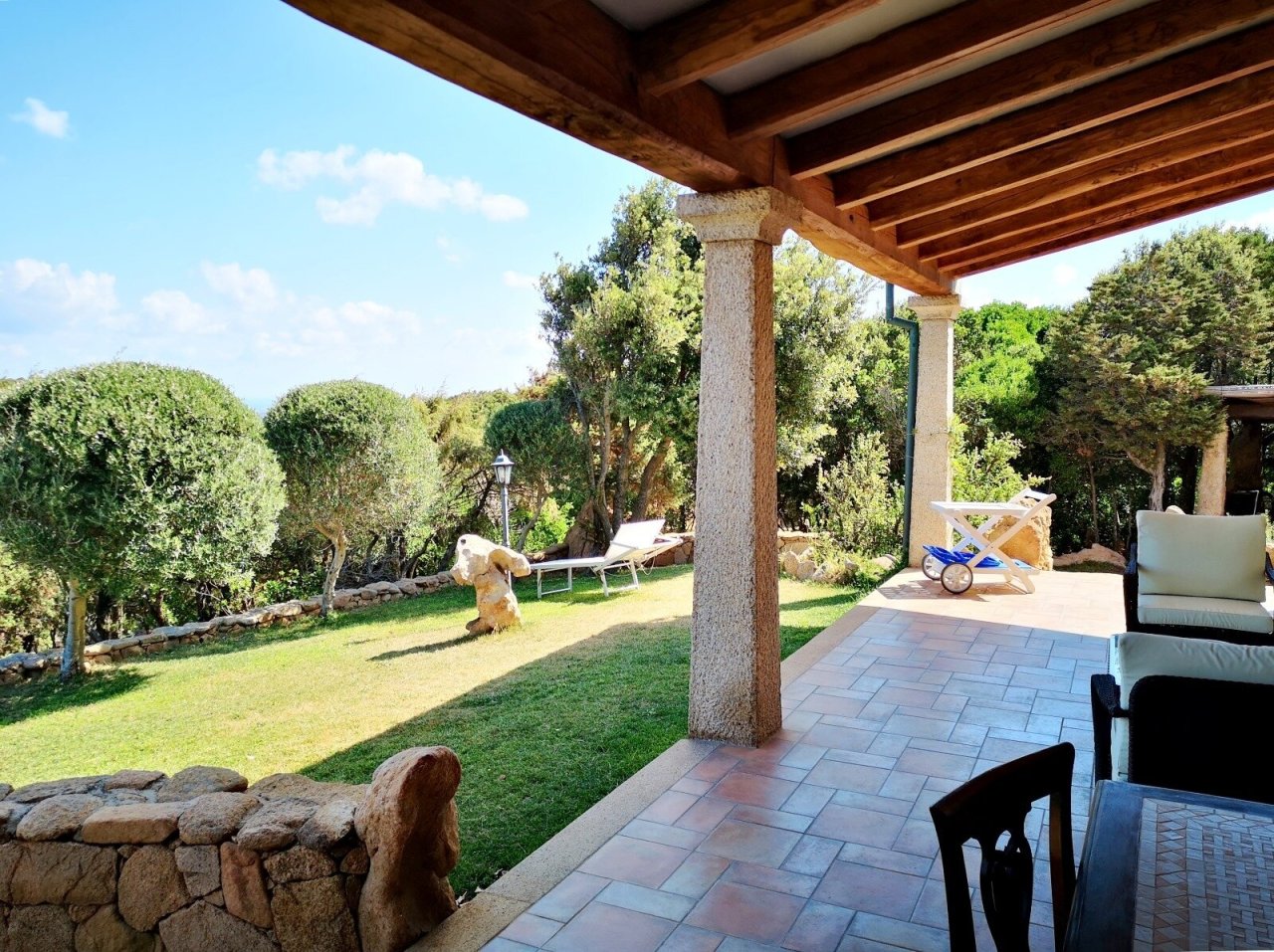 Covered terrace with direct access to park-like garden and natural stone terrace Covered terrace with direct access to park-like garden and natural stone terrace